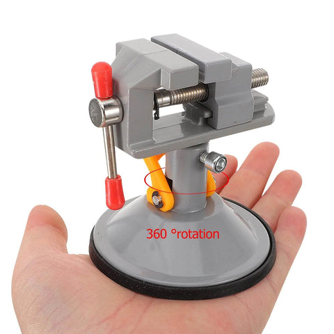 Multi Functional Rotating Bench Vise With Swivel Tabletop Clamp held in hand showcasing 360-degree rotation and compact design.