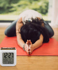 Vintage Tractor Photo Farm Alarm Clock With LED Display on wood floor next to person doing yoga on red mat