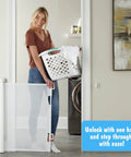 Woman using Retractable Baby Gate With Mesh For Quick Room Conversion And Kid Friendly Living Extends 0 To 55 Inches Wide And 33 Inches High