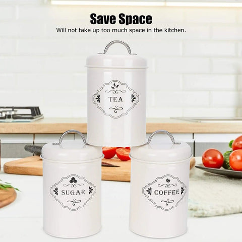 Boost Your Pantry Game With This Three Piece Airtight Kitchen Storage Jar Set Crafted From Thick Powder Coated Iron Heavy Duty Lids. White jars labeled tea, coffee, and sugar.