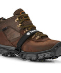 Heavy Duty Tungsten Carbide Spikes For Ice Walkers Large X Large Black Traction Cleats on brown footwear for icy surfaces.