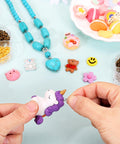 Hands using 7 Color 450 Piece Eye Screw Pins Set Eight By Four Millimeter Tiny Eyelets for bead charms and jewelry making