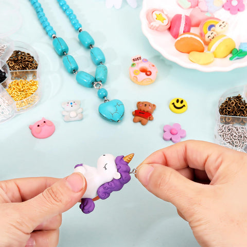 Hands using 7 Color 450 Piece Eye Screw Pins Set Eight By Four Millimeter Tiny Eyelets for bead charms and jewelry making