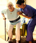 Caregiver assisting elderly woman with Vinyl Gait Belt Transfer for 60 Inch Assistance Devices with Metal Buckle.