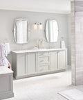 Woman using Gibson Chrome Two-Handle Deck Mounted Modern Roman Tub Faucet T961 with M-Pact Valve Compatibility in modern bathroom.