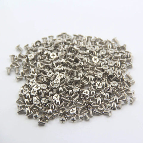 Rock Solid M3x5mm Flat Head Phillips Screws 100 Pack For 2.5 Inch SSD And Hard Drives nickel plated steel fasteners scattered.
