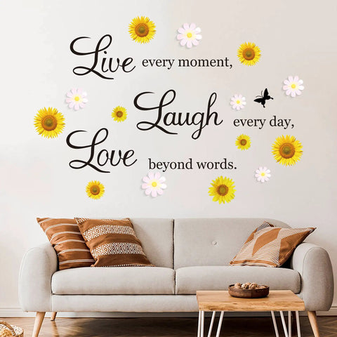 Motivational Daisy Sunflower Wall Decals Set Four Removable Vinyl Quote Stickers 'Live Laugh Love' above a sofa.