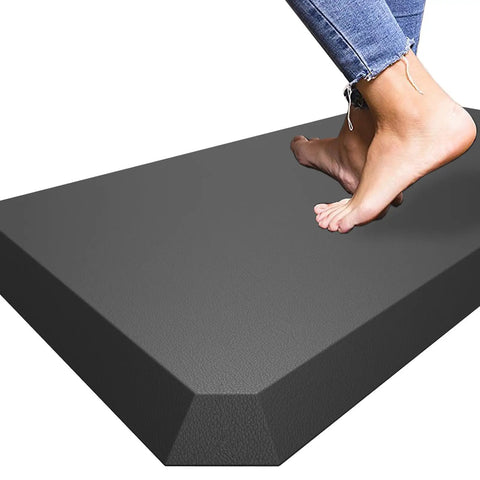 Ultra Thick 0.8 Inch Anti Fatigue Kitchen Mat 17X30 Inches Cushioned Floor Rug Waterproof with feet stepping on the black mat.
