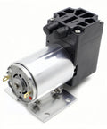 DC 12V vacuum pump with silver cylindrical motor and black control block on metal baseplate (front view)