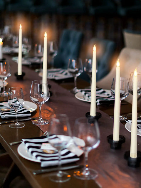 Elegant dining setup with 24 Pack Flameless Taper Candles Battery Operated LED Candles With Realistic Flicker, 11 Inch Ivory Tapered Candles.
