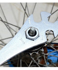 Four Notch BMX Freewheel Remover Tool for sprocket pulling on single speed bikes, shown in use on a wheel hub