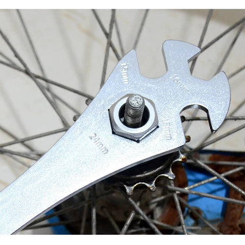 Four Notch BMX Freewheel Remover Tool for sprocket pulling on single speed bikes, shown in use on a wheel hub
