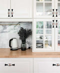 4 Piece Kitchen Cabinet Knobs And Pulls Baseball Line Texture installed on white cabinets with glass panels.