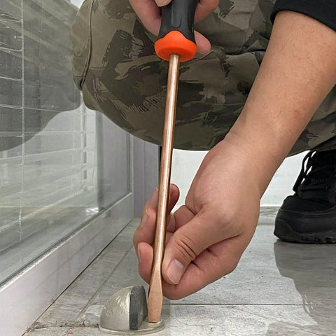 Man using 34 Piece Non Sparking Tool Set Pro Grade Kit flat screwdriver, beryllium copper, adjusting floor fixture.