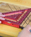 Person using 7.5-Inch Magnetic Rafter Square With Jig Block Multi-Angle Measuring Tool for precise 90-degree lines on wood