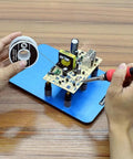 Hands using Six Piece Soldering Helping Hands Set for PCB Boards ESD Safe Metal Magnetic Fixture Tower with Blue Steel Base.