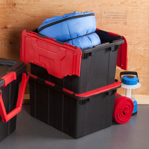 Haul Heavy Loads With Ease Using These Tough As Nails 12 Gallon Storage Totes With Secure Lids For Garage Organization Stackable Heavy Duty Crates Featuring Tie Down Grommets In A Rock Solid 12 Pack Bundle, featuring stacked black bins with red lids and filled with blue bedding.