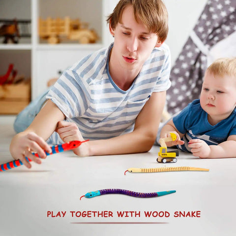 Child and adult playing with a Ten Piece Unfinished Wooden Snakes Craft Kit With Jointed Wiggly Bodies on floor.