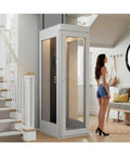 Through Ceiling Compact Home Elevator Shaftless Design For Space Saving Living With Zero Wall Damage Heritage Approved, Customizable Configurations For Homes Farms And Land Projects, Easy Install And Quiet Deck Lift For Modern Homes, white shaftless elevator beside stairs