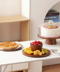 Acacia Wood Cake Stand With Glass Lid, 12 Inch Magnetic Base And Detachable Serving Tray for cakes and snacks on a table display.