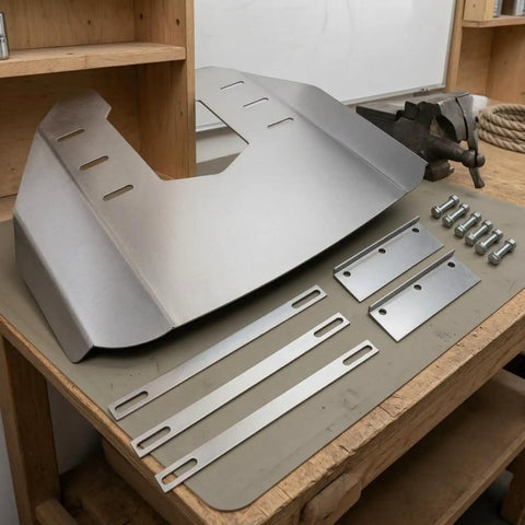 Stainless steel outboard hydrofoil plate with folded wing and mounting hardware for 40-350 HP motors on workbench