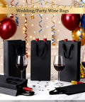 100 Pack Durable Black Paper Wine Carry Bags For Two Bottles Premium Gift Carriers With Free Labels at a festive party table.