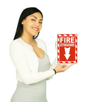Woman holding 7 Inch By 10 Inch Fire Extinguisher Sign Made From Rust Free Aluminum With Bold Text And Symbol for visibility