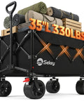 Foldable Wagon With All Terrain Wheels Beefy 150L Capacity Heavy Duty Collapsible Cart For Camping Garden And Sports 330 Lbs Load 31.5 In Long 18.1 In Wide 13.4 In High Black, loaded with camping gear and wood.