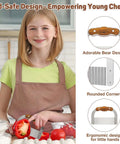 Bear-shaped kid-safe crinkle cutter with rosewood handle and rounded tip used by a girl in a kitchen