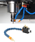Mist coolant spray system for CNC machines installed; blue articulated hose with orange connectors and brass fittings near the spindle.