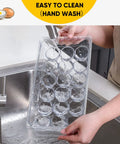 2 Pack Stackable 18 Egg Holder For Refrigerator With Lids being hand-washed, showcasing durable food-grade clear plastic material