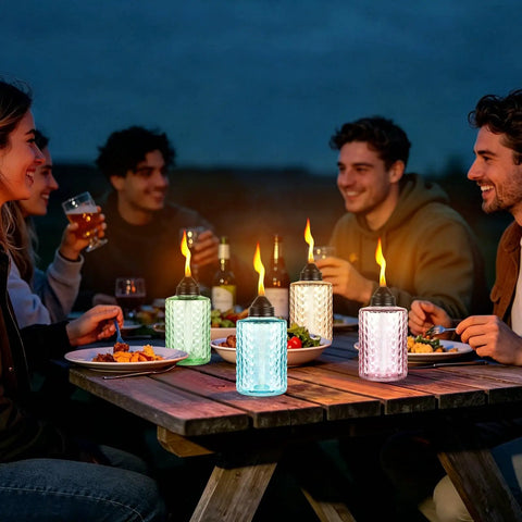 People enjoying outdoor dining with Tabletop Citronella Torches 4 Pack For Outdoor Lighting, Glass Torch Canisters With Wick And Cap, 12oz Each.