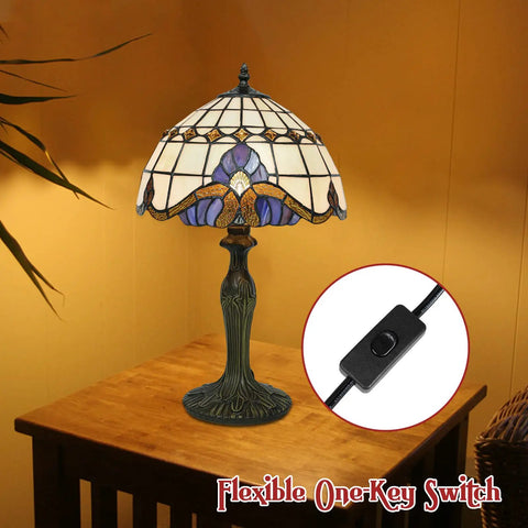 Vintage Tiffany Style Glass Table Lamp With Eye Catching Shade on wooden table, showing antique green bronze base and one-key switch.