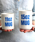 Person holding 11oz and 15oz white ceramic mugs with bold blue text for comparison.