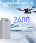 Beefy Mini 2 Series Intelligent Flight Battery 2 Pack 2400mAh with DJI Mini drone flying above snow-covered landscape