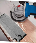 Tough As Nails Cut Resistant Arm Sleeves With Thumb Hole Grip breathable mesh, gray color, shown with a power tool on wood surface.