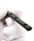 Close-up of a hand holding a T-slot straight connector, part of the Ten Pack Aluminum Extrusion T Slot Straight Connectors With Screws For 20 Series