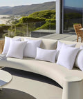 Pack Of 2 18x18 Outdoor Pillow Inserts, Waterproof And Water-Resistant Cushions on patio couch overlooking ocean view.
