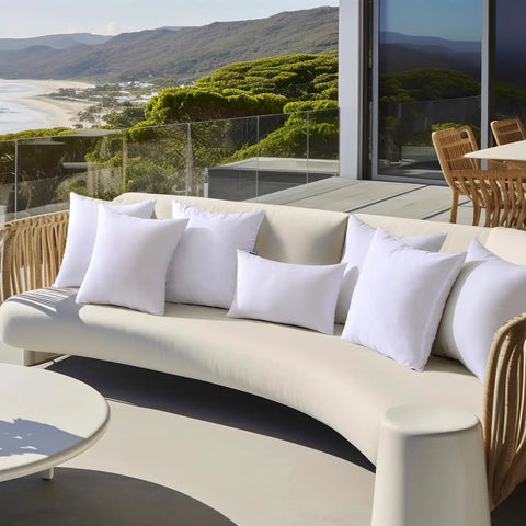 Pack Of 2 18x18 Outdoor Pillow Inserts, Waterproof And Water-Resistant Cushions on patio couch overlooking ocean view.