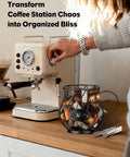 K Cup Holder With Ice Tongs And Large Capacity Coffee Pod Organizer For 10 To 30 Pods Metal Wire K Cup Stand on countertop next to espresso machine.