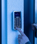 No Drama Smooth Wireless Bluetooth Keypad With Sleek Touch Display For Straight Up Secure Code Entry And Easy Wall Mount Setup In Crisp White Finish For Your Secure Hangout Spot being used to enter a code on a textured wall.