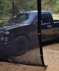 12x24 Ft Black 70 Percent Shade Mesh Tarp With Grommets Beefy Heavy Duty 6 Oz Poly Shade Net in front of truck outdoors