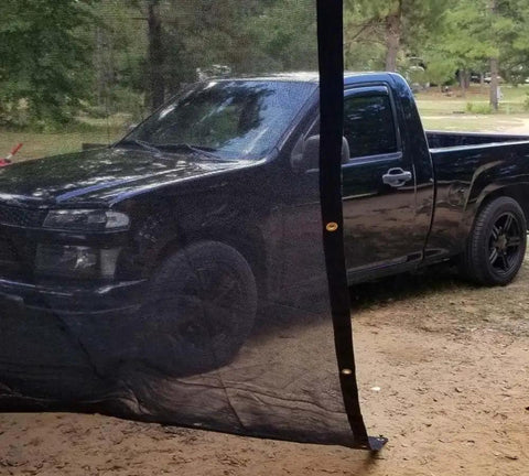 12x24 Ft Black 70 Percent Shade Mesh Tarp With Grommets Beefy Heavy Duty 6 Oz Poly Shade Net in front of truck outdoors
