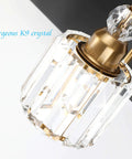 Close-up of crystal lamp on Three Light Black Metal And Crystal Vanity Light Fixture For Modern Bathrooms, gold details visible.