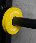 Yellow 1.25 lb fractional weight plate on 2-inch Olympic bar, part of Fractional Weight Plates Set for Incremental Gains on Standard 2 Inch Olympic Bars.