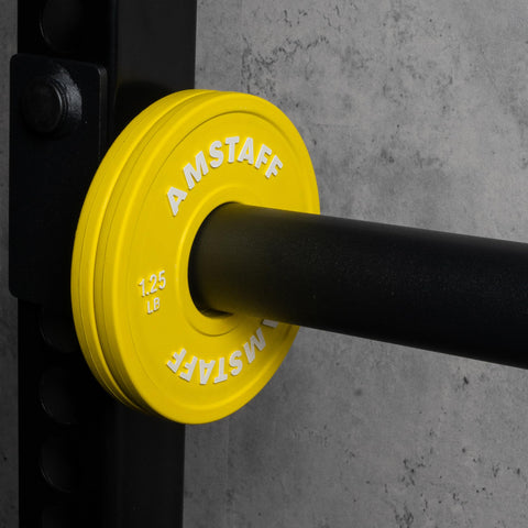 Yellow 1.25 lb fractional weight plate on 2-inch Olympic bar, part of Fractional Weight Plates Set for Incremental Gains on Standard 2 Inch Olympic Bars.