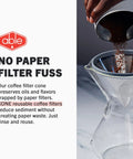 Hand pouring coffee grounds into Chemex with reusable stainless steel filter, no paper filter fuss text
