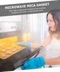 Woman using oven with Mica Insulation Sheets For Microwave Oven 10 Pack Heat Resistant Pads And Plates, Easy To Cut To Size.