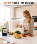 Woman using Alexa-enabled device in kitchen, smart home interaction with fruits and vegetables on the counter.