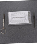 Premium Stainless Steel Micro Screw Kit With Tiny Screwdriver And Tweezers Dead Simple Glasses And Watch Repairs on gray background.